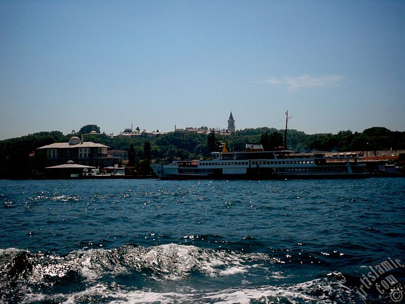 View of Eminonu coast, ships and Topkapi Palace from the sea in Istanbul city of Turkey.
